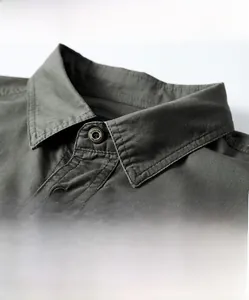Detail shot of army green cotton shirt collar and shoulder with tactical stitching