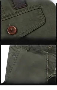 Detail view of olive green cargo shorts featuring high-quality stitching and metal zippers