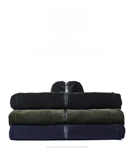 Detail of stacked corduroy jackets in black, navy, and dark green with textured ribbing