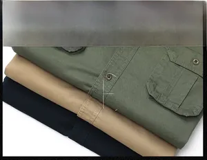 Detail of cotton twill shirts showing double pockets and metallic buttons in three colors
