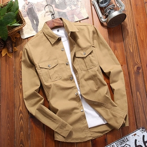 Classic khaki cotton long-sleeve cargo shirt with double pockets on a wooden floor