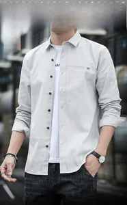 Detail of grey men's long-sleeve shirt with black buttons and decorative pocket
