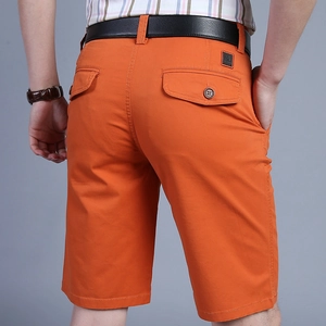 Back view of orange men's cotton casual shorts with cargo pockets and black belt