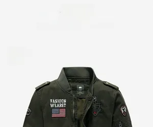 Detail view of military army green jacket showing embroidered patches and shoulder epaulets