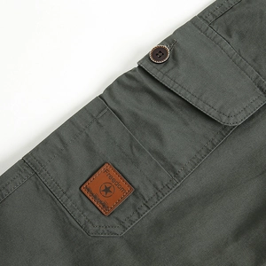 Army green cargo pants with leather freedom patch and detailed pocket stitching