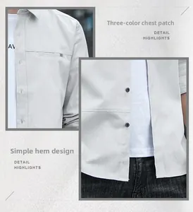 Detail of light gray shirt featuring tri-color ribbon tag and textured fabric finish