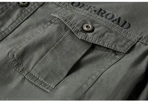 Detail of chest pocket with OFF-ROAD print and button on cotton work shirt
