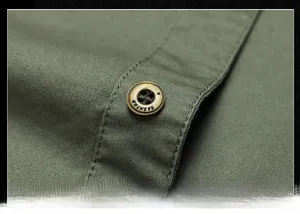 Macro shot of olive green cotton shirt showing fashion engraved button and neat stitching