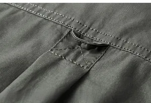 Detail of dark gray workwear shirt showing hanging loop and durable double stitching