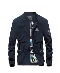 Close-up of men's navy baseball jacket featuring zipper, chest embroidery and printed lining