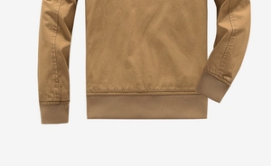 Detail view of khaki cotton canvas jacket showing ribbed hem and cuff craftsmanship