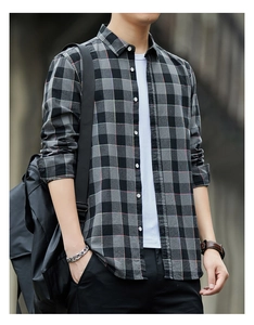 Close-up detail of grey and black plaid cotton shirt showing fabric texture and buttons