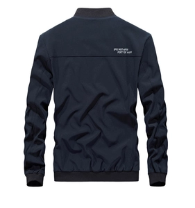 Detail of navy blue baseball jacket back featuring white printed letters and ribbed collar