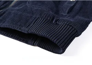 Detail shot of the ribbed hem on a deep blue corduroy jacket for men's casual wear