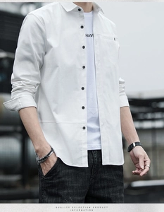 Detail of white long-sleeved shirt with black buttons and small turnover collar