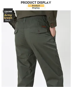 Detail view of military green pants featuring an elastic waist and back flap button pocket