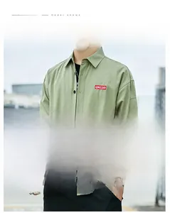 Close-up of green long sleeve shirt showing brand tag and non-iron fabric detail
