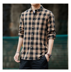 Detailed close-up of brown and black plaid pattern on a men's long sleeve cotton shirt