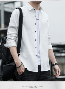 Detail of white long-sleeved shirt featuring black buttons and a single chest pocket