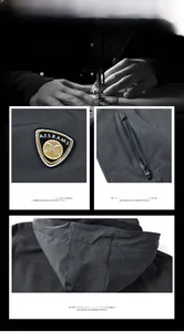 Detail view of windproof hood, embroidered crest, and secure zipper pockets on gray jacket