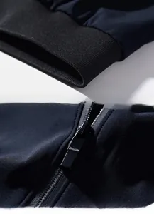 Detailed macro view of the elastic ribbed hem and black metal fashion zipper on a blue jacket