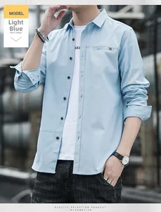 Close-up of light blue long sleeve shirt with striped pocket detail and button-up front