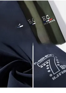 Detailed close-up of embroidered logo and fabric texture on men's outdoor casual jacket