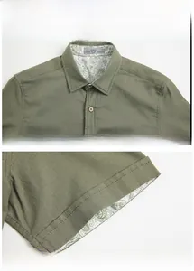Detail of olive green linen shirt with paisley pattern lining and wooden buttons