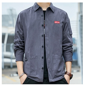 Close-up of gray cargo jacket with front pockets and red brand patch on the chest