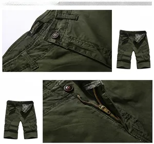 Detail view of military green cotton cargo shorts showing multi-pocket design and zipper fly