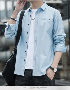 Close-up of light blue shirt pocket with tri-color ribbon detail and white inner T-shirt