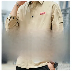 Detail of khaki men's utility shirt with black buttons and QINGLIAN pocket logo