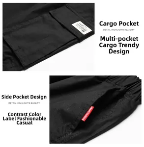 Detail of black cargo shorts featuring large side pockets and embroidered woven labels
