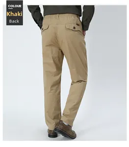 Detail view of khaki casual trousers featuring elastic waist and buttoned back pockets