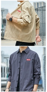 Detail of cargo shirts showing embroidered logo patch and large utility pockets on chest