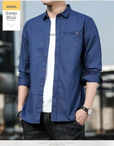 Detail of dark blue men's casual shirt with collar pocket and decorative ribbon accent