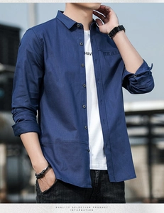 Detail of navy blue long sleeve shirt with classic lapel and textured cotton-linen fabric