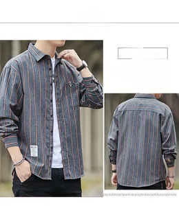 Close-up of dark grey long-sleeve shirt with orange vertical stripes and pocket detail