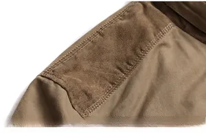 Detailed macro view of khaki casual jacket shoulder with reinforced mixed fabric stitching