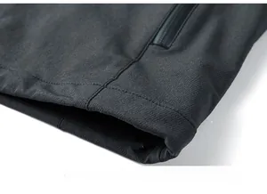 Close-up of the smooth hemline and concealed zipper pocket on the men's outdoor jacket