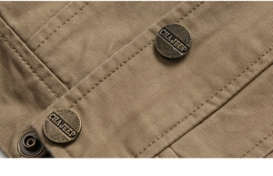 Detailed close-up of khaki cotton twill jacket with double stitching and metal button