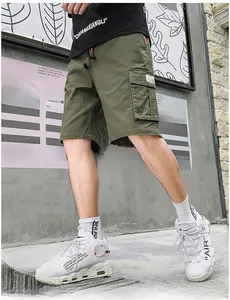 Detail view of army green cargo shorts featuring large side flap pockets and drawstrings