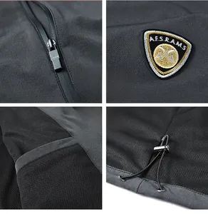 Detail of waterproof zipper, embroidered badge, and adjustable drawstring on outdoor jacket