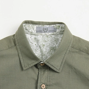 Men's casual olive green short sleeve shirt with paisley collar lining and wood buttons