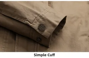 Detailed macro view of khaki cotton jacket cuffs with branded embossed metal buttons