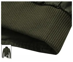 Detail view of military green jacket ribbed hem with fine double stitching