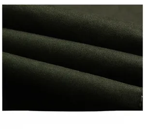 Macro shot of dark olive green jacket featuring premium twill fabric texture and weave detail