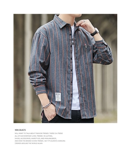 Detailed view of vertical striped texture and chest pocket on long sleeve men shirt