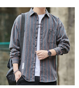 Detail of grey striped long sleeve shirt with chest pocket and decorative triangle tag