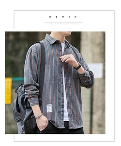Detailed view of men's dark grey striped shirt featuring retro orange vertical patterns
